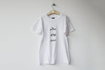 Salaam Shalom Peace in Arabic, Hebrew & English. White T-shirt with Black Writing. Simple and Minimal. Capsule Wardrobe.